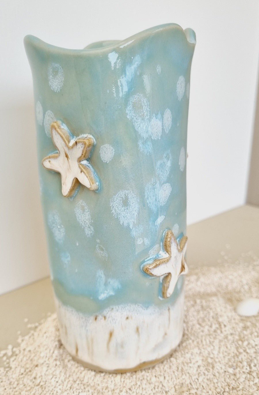 Handmade whimsical beach decor vase. Decorated with ceramic starfish