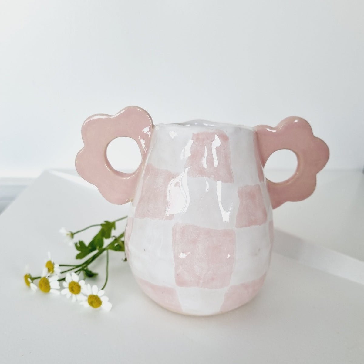 Mini ceramic vase handmade. Two handles on the side in pink. Handpainted pink checkers