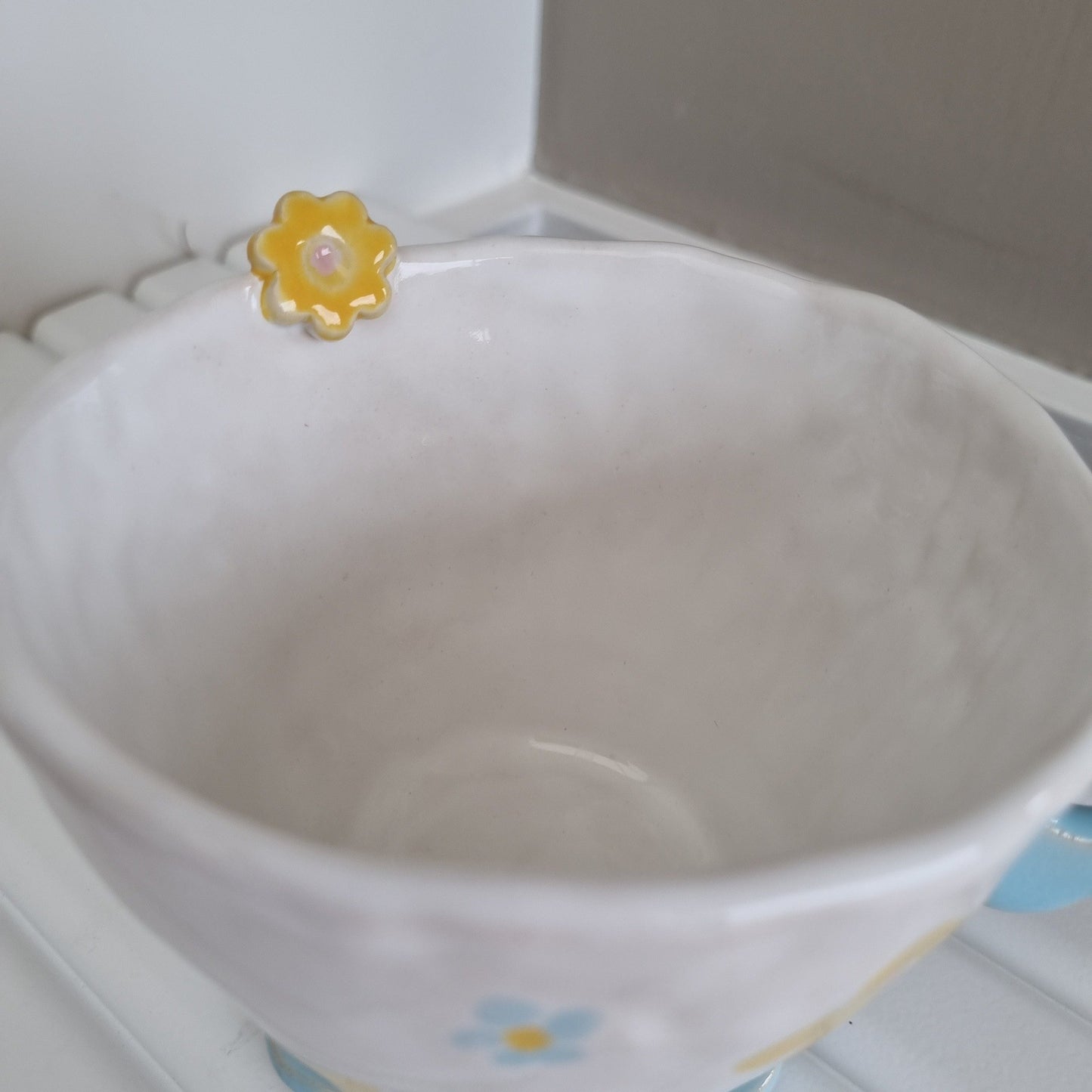 Detail of ceramic flower on the rim