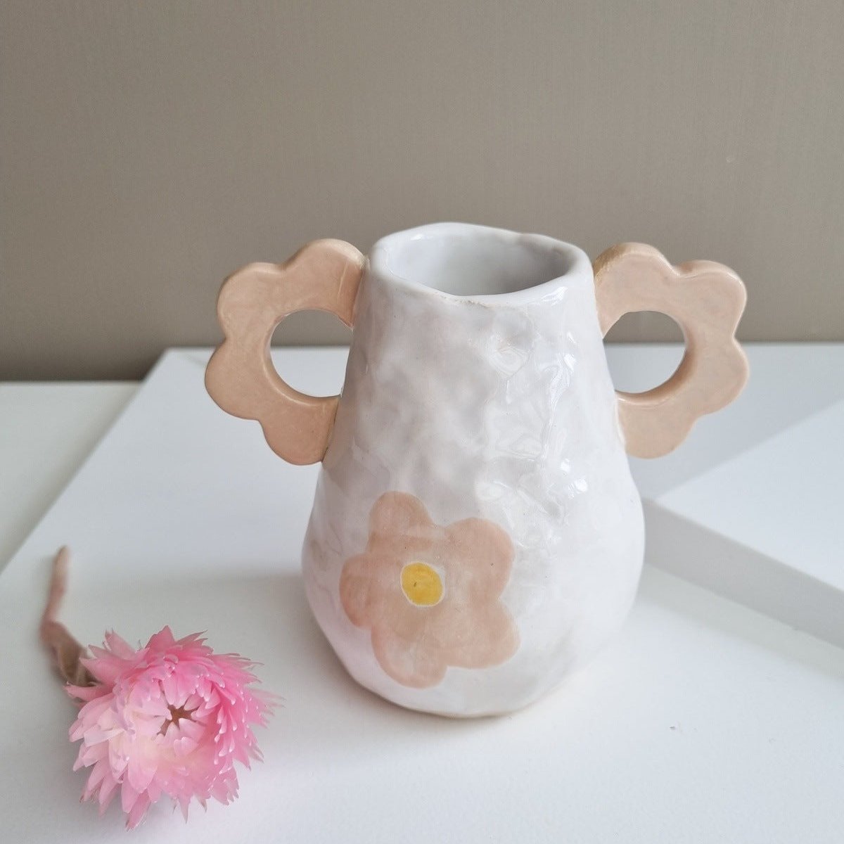 Small handmade ceramic vase. Two handles in flower shape. Handpainted large flower