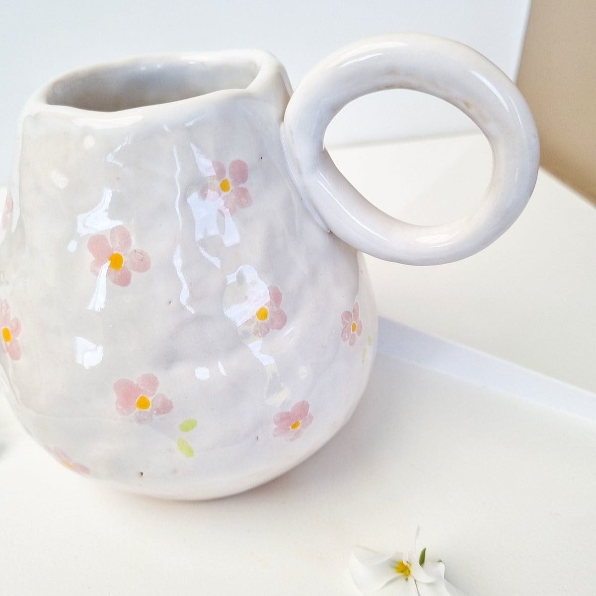 Wobbly white vase handpainted with pink flowers.