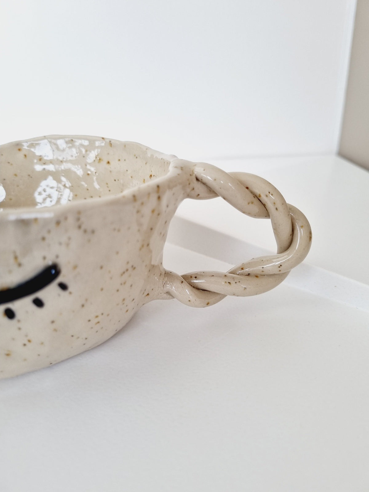 Handmade hand shaped whimsical mug with face, speckled clay.