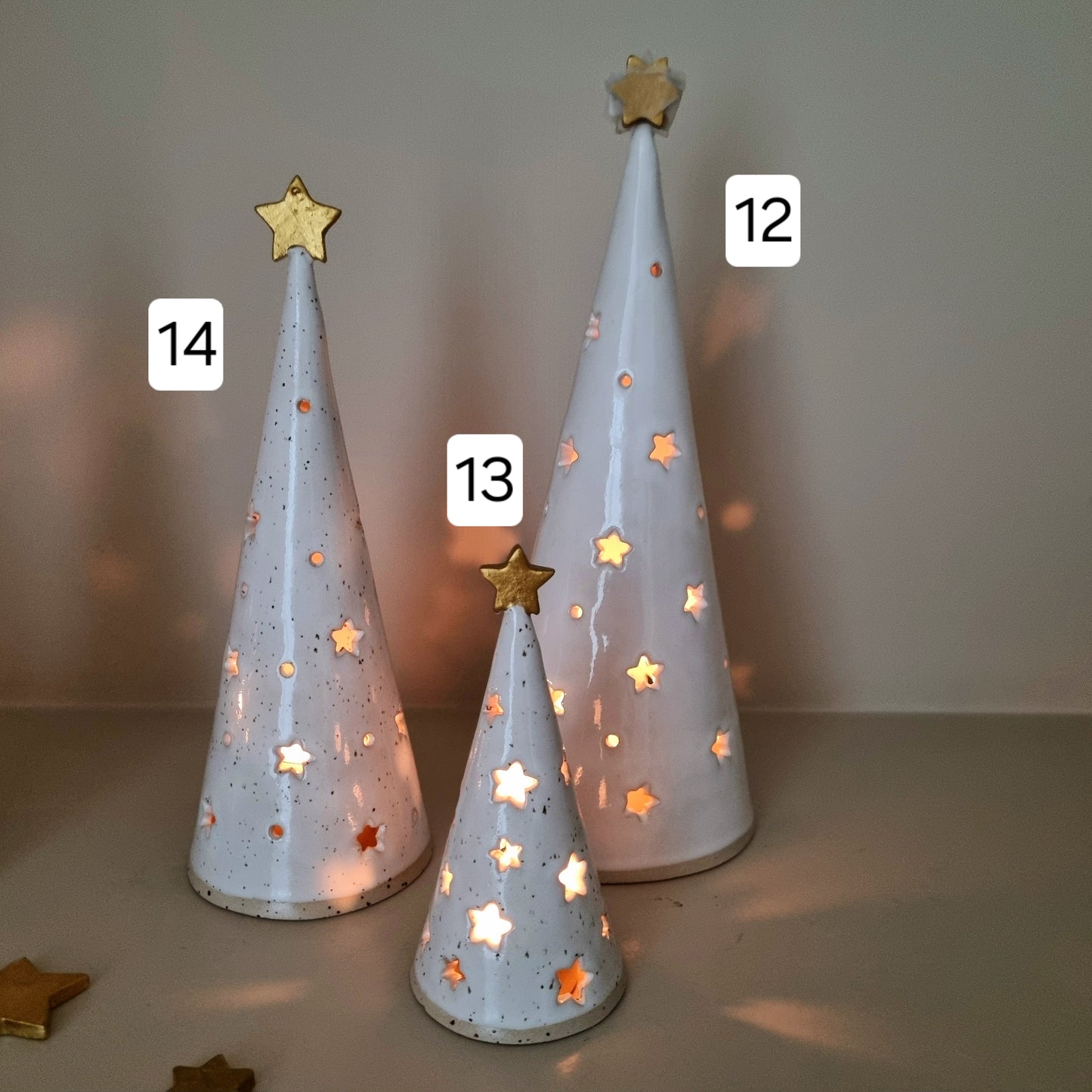 Ceramic Christmas Trees, white pierced with star cut outs. Made from speckled clay.