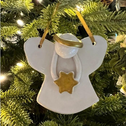 White ceramic Christmas angel ornament, handmade, with golden accents.