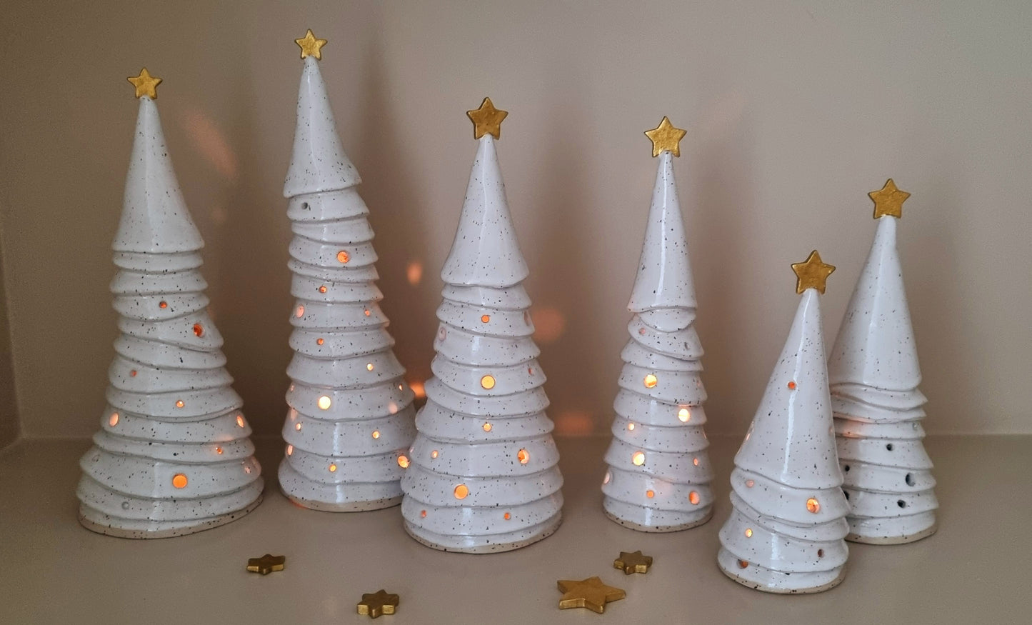 Group of ceramic Christmas trees with golden stars