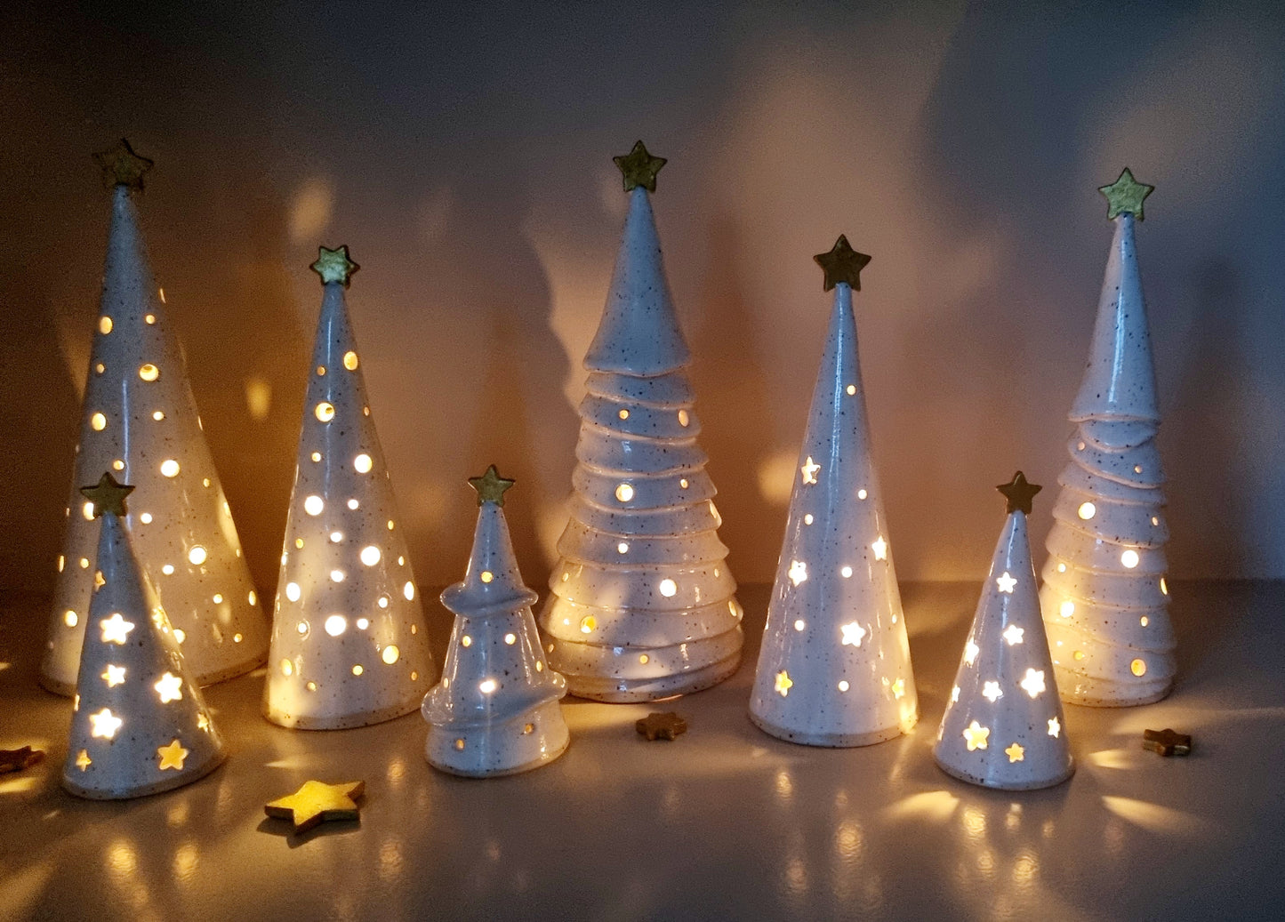 Group ceramic Christmas trees pierced.