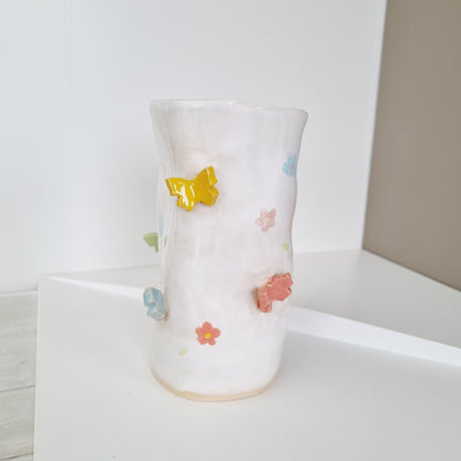 Handmade white vase with colorful butterflies