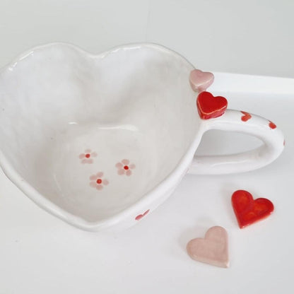 Whimsical mug handmade in a heart shape. ceramic hearts on the rim