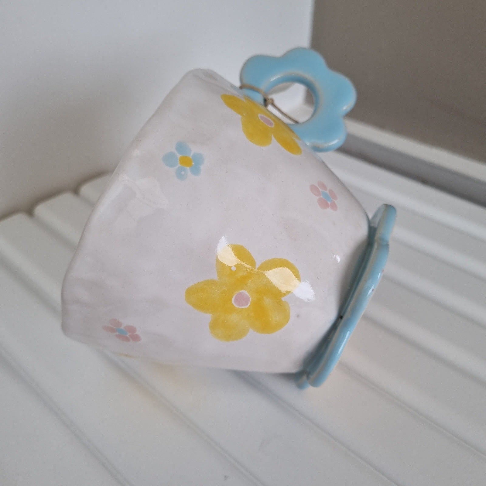 Cute girly mug with handpainted yellow and blue flowers.