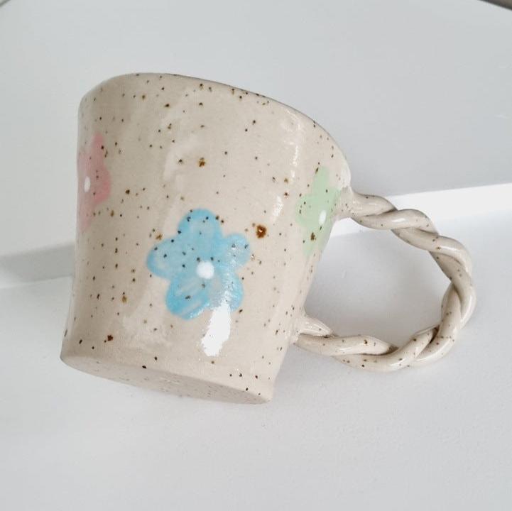 Speckled mug handmade, handpainted with green, pink and blue flowers. Braided handle