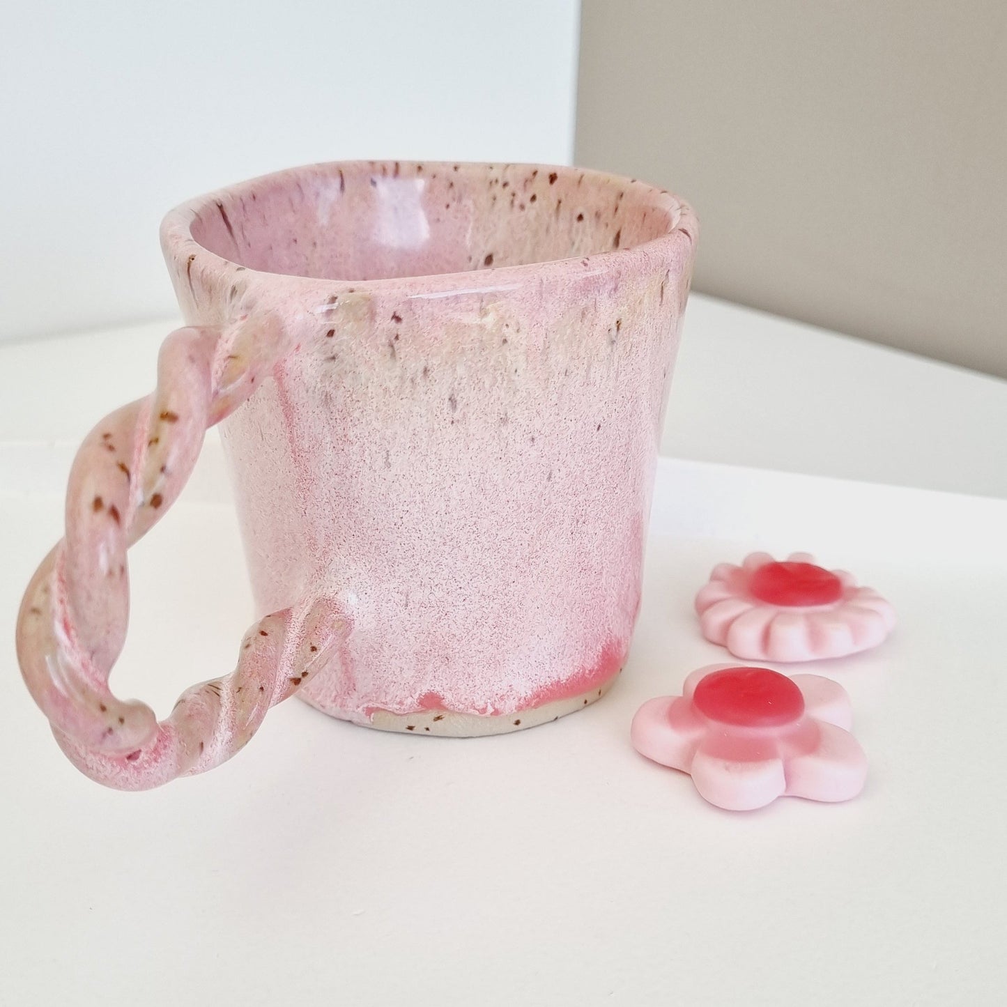 Pink mug with drippy glaze. Braided handle for a girly, cute look