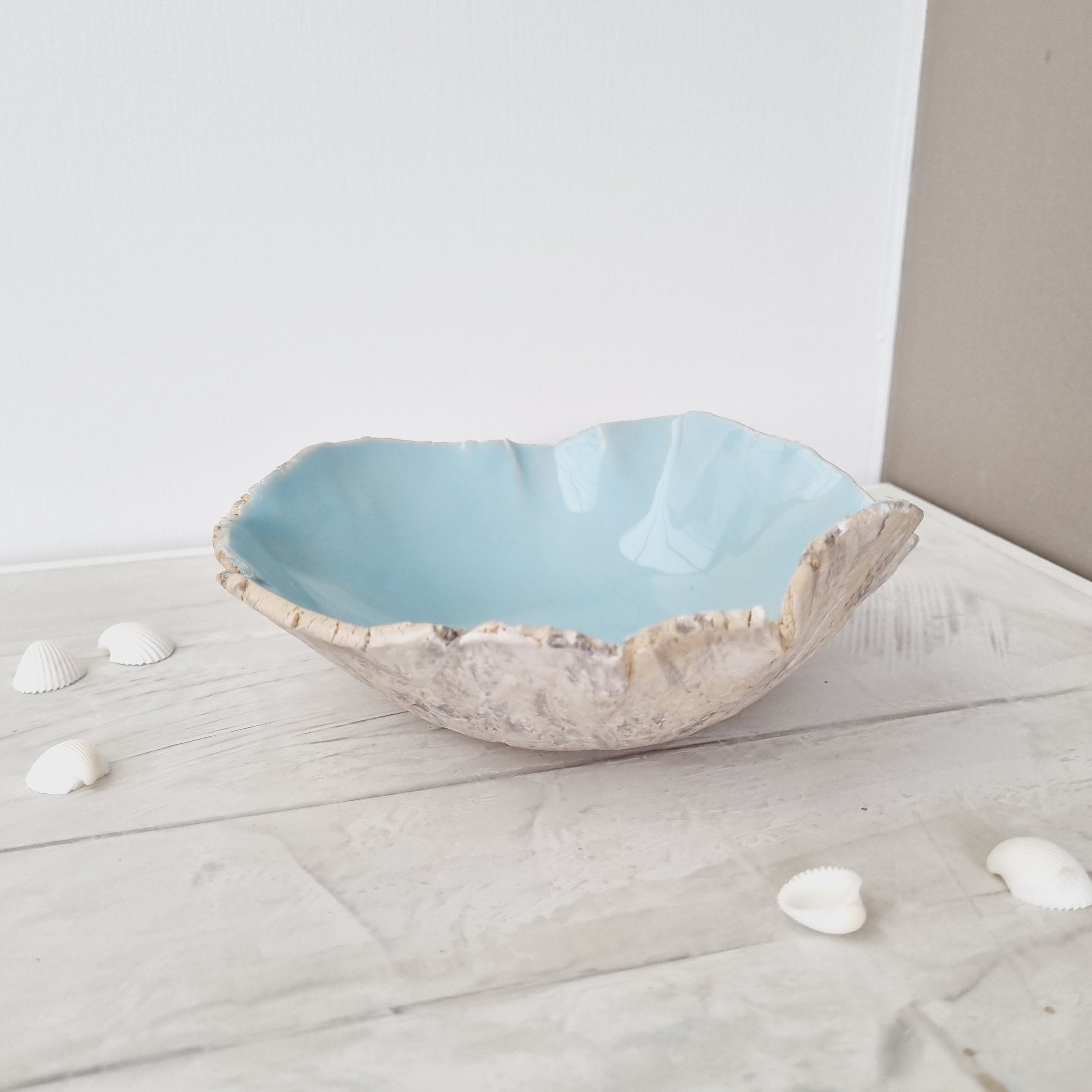 Coastal style bowl in beautiful turquoise inside. The outside is inspired by the beach