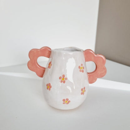 Tiny handmade vase with two handles on the side