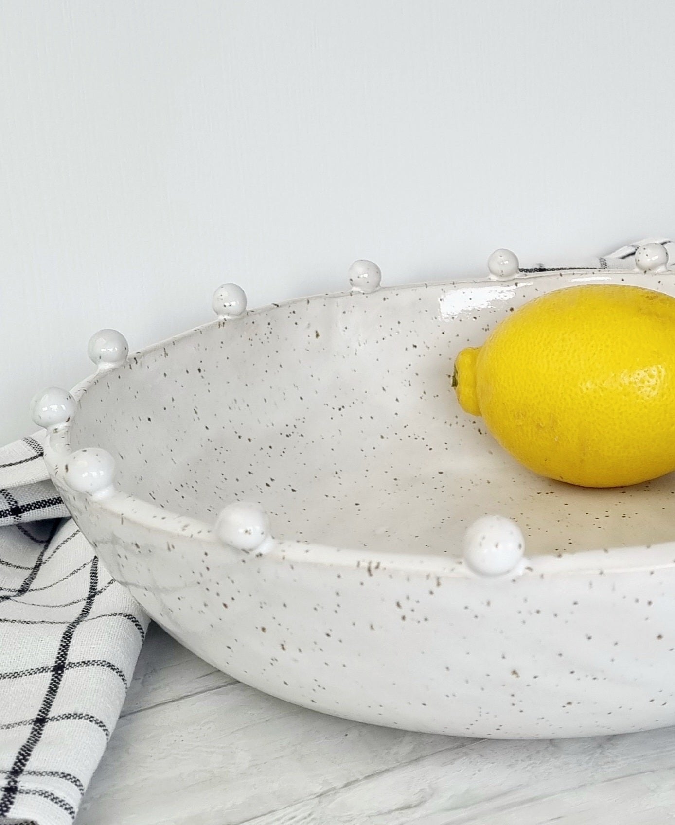 Ceramic bowl with balls on the rim