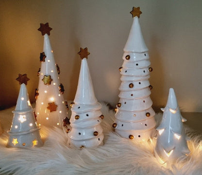 White ceramic Christmas trees handmade decorated with golden ornaments