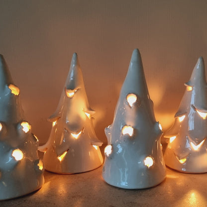 Small white handmade ceramic trees with cut outs