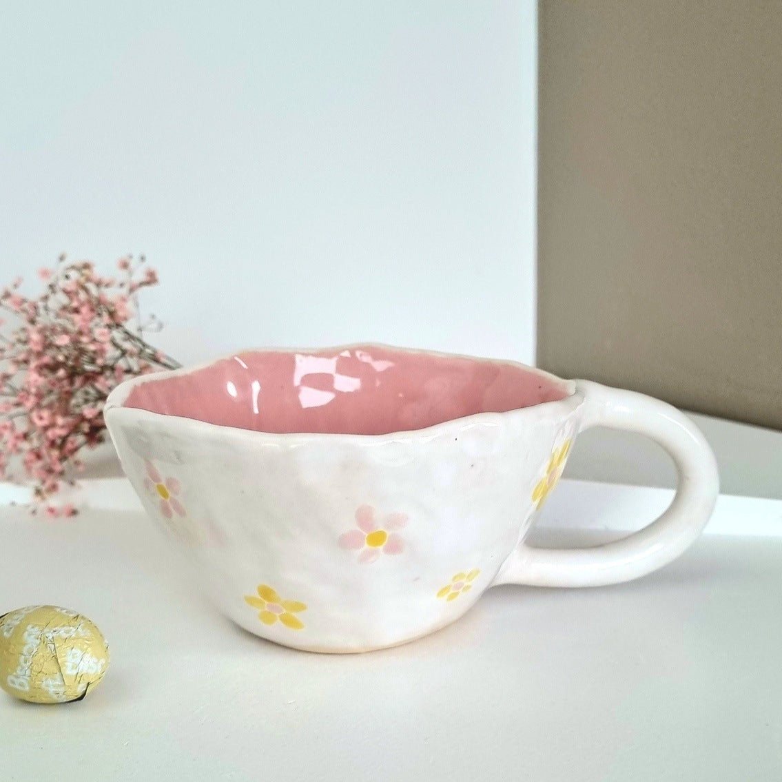 Handpainted wide mug with pink flowers on a white base. 